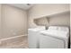 Bright laundry room featuring a white washer and dryer set and neutral paint at 8515 W Peppertree Ln, Glendale, AZ 85305