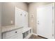 Mudroom area with white storage cabinets, granite countertops and hooks at 8515 W Peppertree Ln, Glendale, AZ 85305