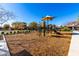 A sunny playground area with climbing structures and swings, surrounded by homes in the neighborhood at 8515 W Peppertree Ln, Glendale, AZ 85305