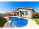 Private backyard pool surrounded by tile pavers and green turf at 8515 W Peppertree Ln, Glendale, AZ 85305