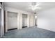 Bedroom with carpet, ceiling fan, and double door closet storage at 10420 W Tropicana Cir, Sun City, AZ 85351