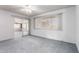 Sunlit bedroom with ceiling fan and sliding doors to additional room at 10420 W Tropicana Cir, Sun City, AZ 85351