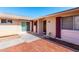 Inviting single-story home featuring brick accents, covered entry, and well-lit walkway at 10420 W Tropicana Cir, Sun City, AZ 85351