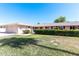 Charming single-story home with manicured lawn and inviting entryway at 10420 W Tropicana Cir, Sun City, AZ 85351