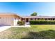 Charming single-story home with manicured lawn and inviting entryway at 10420 W Tropicana Cir, Sun City, AZ 85351