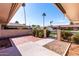 Welcoming courtyard showcasing brick accents, lush greenery, and a secure wrought iron gate at 10420 W Tropicana Cir, Sun City, AZ 85351