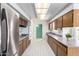 Galley-style kitchen featuring stainless steel appliances and bright lighting at 10420 W Tropicana Cir, Sun City, AZ 85351