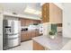 Functional kitchen featuring stainless steel appliances and wood cabinets at 10420 W Tropicana Cir, Sun City, AZ 85351