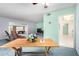 Bright living room with blue carpet and mint walls leading to an additional room at 10420 W Tropicana Cir, Sun City, AZ 85351