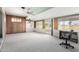 Sunlit living space with neutral carpeting, sliding doors, and ample natural light at 10420 W Tropicana Cir, Sun City, AZ 85351