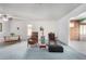 Bright living room featuring neutral walls, plush carpeting, and comfortable seating options at 10420 W Tropicana Cir, Sun City, AZ 85351