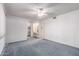 Main bedroom featuring a ceiling fan, vanity area, and neutral color scheme at 10420 W Tropicana Cir, Sun City, AZ 85351