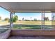 Covered patio overlooking a golf course with green grass at 10420 W Tropicana Cir, Sun City, AZ 85351