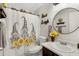 View of a bathroom with decorative shower curtain, sunflower details, vanity, light, round mirror and tiling at 10515 W Pasadena Ave, Glendale, AZ 85307