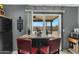 View of a kitchen island with a table, red chairs, and sliding glass door looking out into the backyard at 10515 W Pasadena Ave, Glendale, AZ 85307