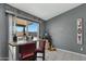 View of a kitchen island with a table, red chairs, and sliding glass door looking out into the backyard at 10515 W Pasadena Ave, Glendale, AZ 85307