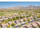 Expansive aerial shot capturing a desert community with lush landscaping and mountain views at 10558 E Meadowhill Dr, Scottsdale, AZ 85255