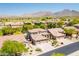 Stunning aerial view of a desert community with mountain backdrop, homes featuring tile roofs and desert landscaping at 10558 E Meadowhill Dr, Scottsdale, AZ 85255