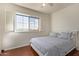 Bedroom with hardwood floors, white shutters and a white upholstered headboard at 10558 E Meadowhill Dr, Scottsdale, AZ 85255