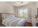 Bedroom featuring wood floors, ceiling fan and window with view of the lush landscape at 10558 E Meadowhill Dr, Scottsdale, AZ 85255