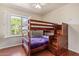 Bedroom with wood floors, window with white shutters, and a wooden bunk bed at 10558 E Meadowhill Dr, Scottsdale, AZ 85255