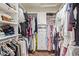 Walk-in closet featuring built-in shelving and ample storage for clothes and shoes at 10558 E Meadowhill Dr, Scottsdale, AZ 85255