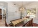 Bright dining room with a modern chandelier and a view of the backyard at 10558 E Meadowhill Dr, Scottsdale, AZ 85255