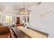 Dining room with modern lighting and open access to the living room at 10558 E Meadowhill Dr, Scottsdale, AZ 85255