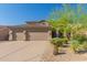 A beautiful home with a three-car garage and well-maintained desert landscaping with desert trees and native plants at 10558 E Meadowhill Dr, Scottsdale, AZ 85255