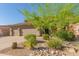 A beautiful home with a three-car garage and well-maintained desert landscaping with desert trees and native plants at 10558 E Meadowhill Dr, Scottsdale, AZ 85255