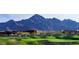 Scenic golf course view with sand traps and mountain backdrop in a desert community at 10558 E Meadowhill Dr, Scottsdale, AZ 85255