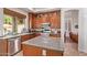 Kitchen featuring stainless appliances, wooden cabinetry, and a granite countertop island at 10558 E Meadowhill Dr, Scottsdale, AZ 85255