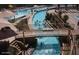 Aerial view of a community lazy river with bridge and several people enjoying the cool water at 10558 E Meadowhill Dr, Scottsdale, AZ 85255