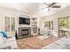 Bright living room with a fireplace, modern decor, and sliding doors to the backyard at 10558 E Meadowhill Dr, Scottsdale, AZ 85255