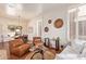 Bright living room with plantation shutters, hardwood floors, and an adjacent dining area perfect for entertaining at 10558 E Meadowhill Dr, Scottsdale, AZ 85255