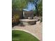 Outdoor lounge area with a covered daybed and lush landscaping, perfect for relaxation and privacy at 10558 E Meadowhill Dr, Scottsdale, AZ 85255