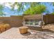 Outdoor seating area with a shaded daybed on a paver patio surrounded by lush desert vegetation at 10558 E Meadowhill Dr, Scottsdale, AZ 85255