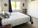 Serene bedroom featuring a queen bed, natural lighting, and a closet for storage at 1132 S 81St Pl, Mesa, AZ 85208