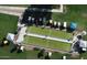 Aerial view of a well-maintained bocce ball court, surrounded by lush green grass and lined with golf carts at 1132 S 81St Pl, Mesa, AZ 85208