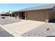 View of home with a long driveway, neutral exterior, xeriscaping and a two car garage at 1132 S 81St Pl, Mesa, AZ 85208