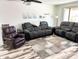 Comfortable living room featuring a reclining loveseat and chair on wood-look floors at 1132 S 81St Pl, Mesa, AZ 85208