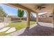 Inviting covered patio with a ceiling fan overlooks the well-maintained backyard at 12603 W Blackstone Ln, Peoria, AZ 85383