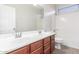 Bathroom with double sinks, wood cabinets and a shower and toilet area at 12603 W Blackstone Ln, Peoria, AZ 85383