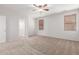 This primary bedroom features neutral colored walls, a ceiling fan, two windows, and carpet floors at 12603 W Blackstone Ln, Peoria, AZ 85383