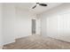 Clean bedroom with closet and ensuite door, carpeted in neutral color and ceiling fan at 12603 W Blackstone Ln, Peoria, AZ 85383