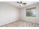 Bedroom with carpet, ceiling fan, window, and neutral colored walls at 12603 W Blackstone Ln, Peoria, AZ 85383