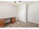 Bedroom with neutral carpet, closet with sliding doors, and built-in desk at 12603 W Blackstone Ln, Peoria, AZ 85383