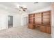 Spacious bonus room features built-in shelves and cabinetry with neutral carpeting at 12603 W Blackstone Ln, Peoria, AZ 85383