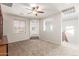 Bright bonus room features soft carpeting, arched doorways, and a ceiling fan at 12603 W Blackstone Ln, Peoria, AZ 85383