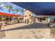 Community center entrance featuring palm trees, shade structures, and modern design elements at 12603 W Blackstone Ln, Peoria, AZ 85383